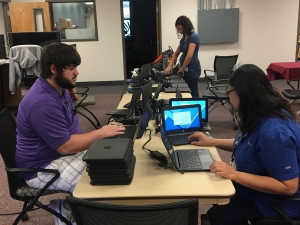 Technical Services staff Prepare Chromebooks for delivery to Schools